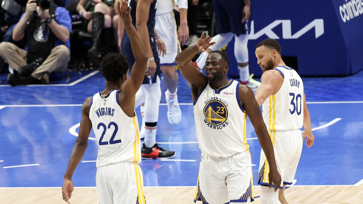 Golden State Warriors forward Andrew Wiggins (22) and Golden State Warriors forward Draymond Green (23) and Golden State Warriors guard Stephen Curry.